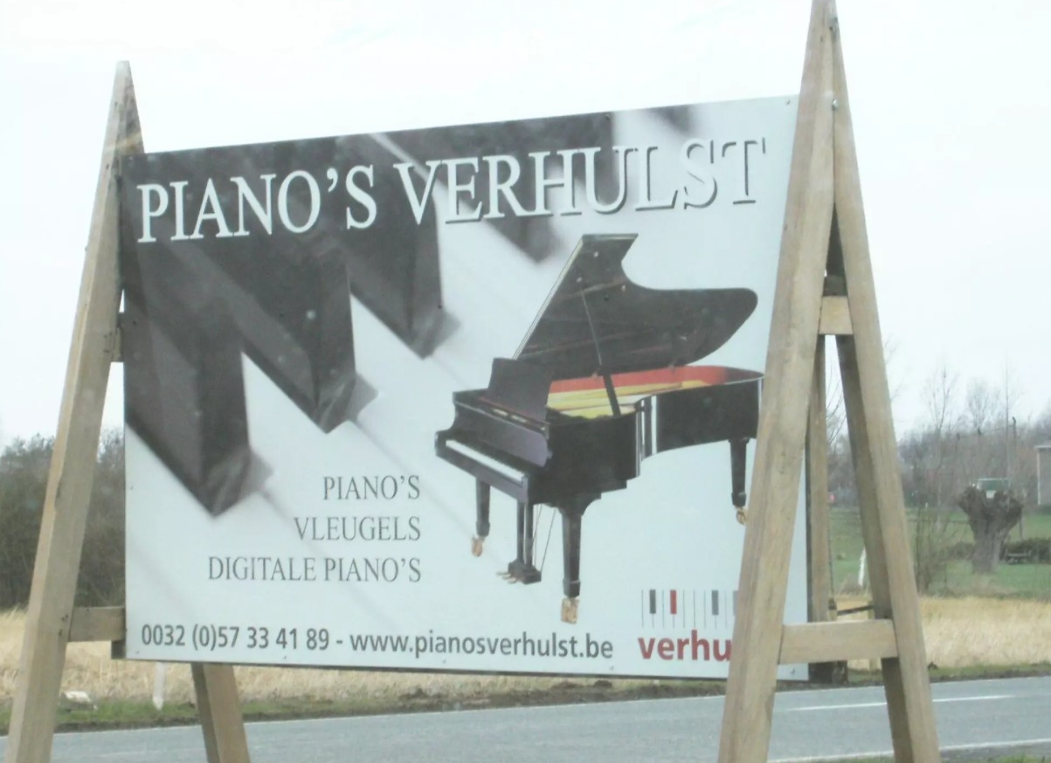 Reclamepaneel bij tweede winkel Piano's Verhulst